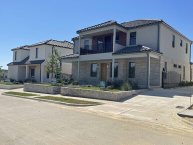 Two homes on a street in a suburban neighborhood.