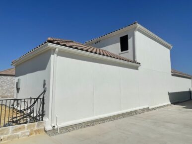 A white house with a fence and a gate.