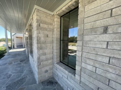 A house with a stone walkway and a window.