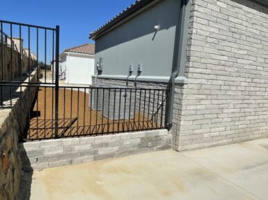 A house with a black fence and a black gate.