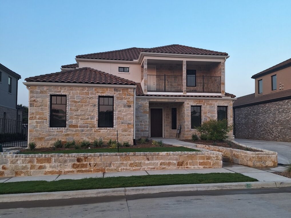 936 El Dorado St A home with a stone front and a brick driveway.
