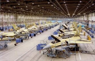 F-16 fighter jets in a large hangar.