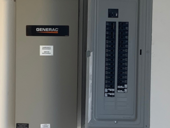 A black and white electrical panel with a switch and a circuit breaker.