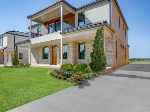 A home with a large front yard and a driveway.