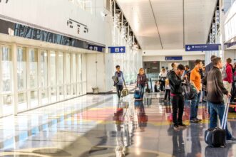 A group of people standing in line at an airport.