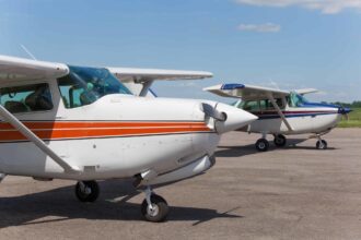 Two small airplanes parked on the tarmac.